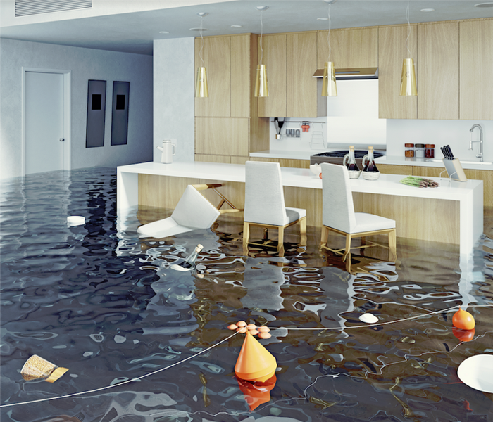 a flooded kitchen with water and belongings everywhere